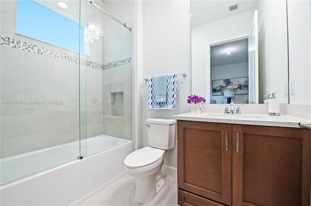 full bathroom featuring vanity, tile patterned floors, shower / bath combination with glass door, and toilet