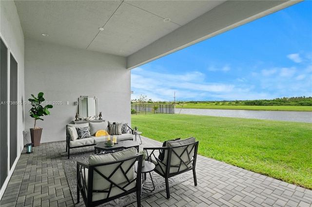 view of patio / terrace featuring a water view and outdoor lounge area