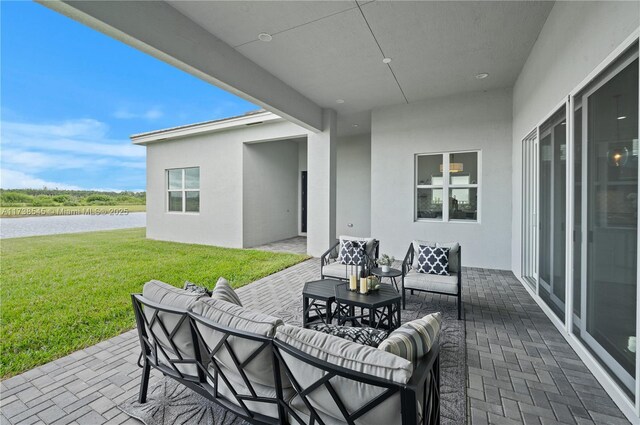 view of patio / terrace featuring a water view and outdoor lounge area