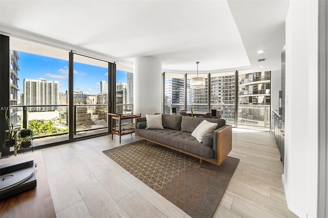 living room featuring floor to ceiling windows and light wood-type flooring