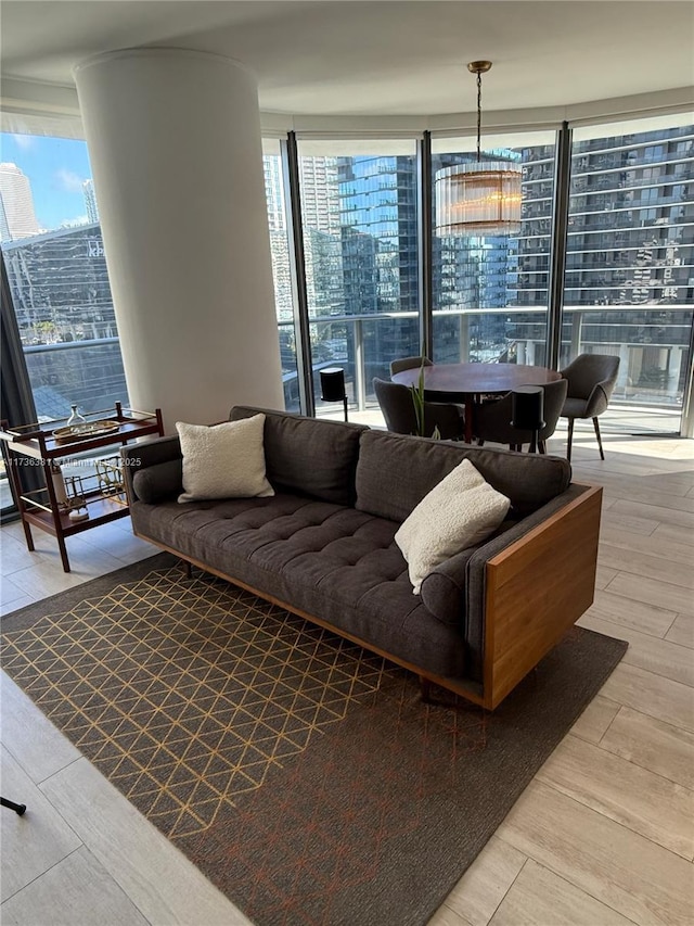 living room featuring floor to ceiling windows and light hardwood / wood-style flooring