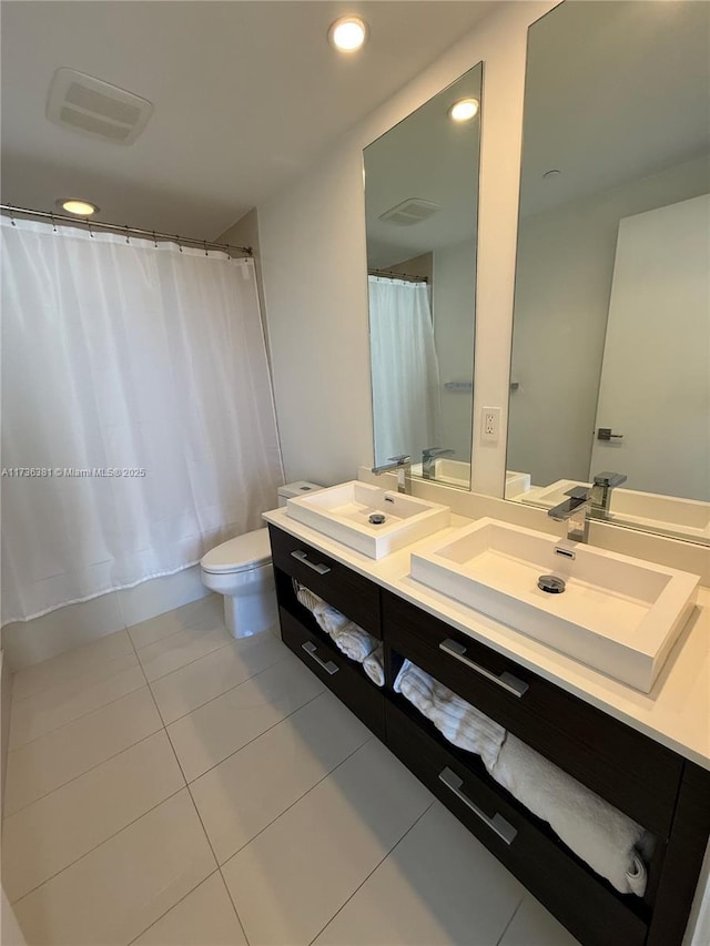 bathroom with vanity, tile patterned floors, and toilet