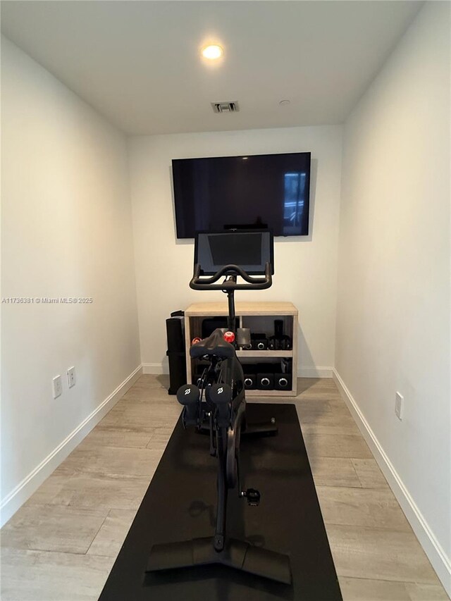 workout room featuring light hardwood / wood-style floors