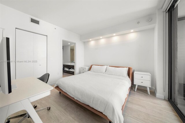 bedroom with a closet and light wood-type flooring