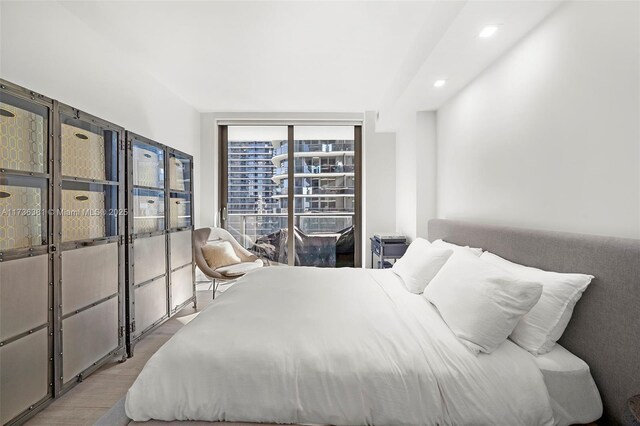 bedroom featuring floor to ceiling windows and light wood-type flooring