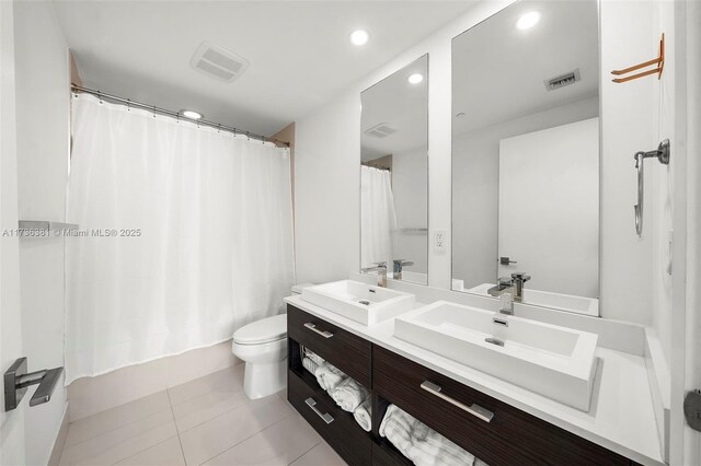 full bathroom featuring shower / bathtub combination with curtain, vanity, toilet, and tile patterned flooring