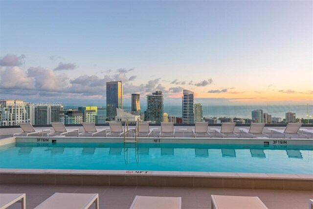 view of pool at dusk