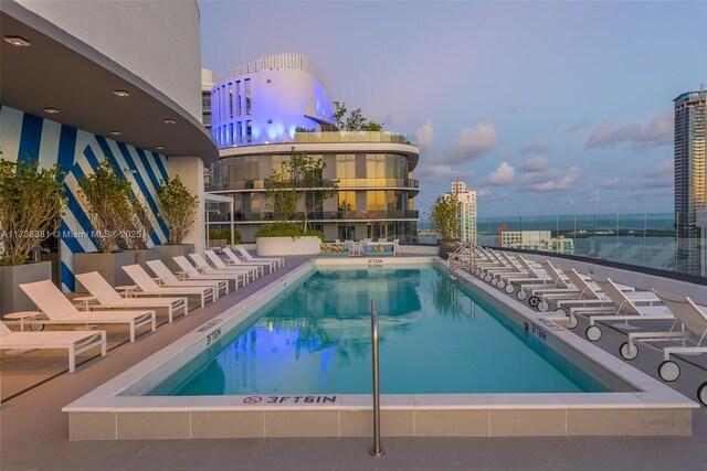 view of pool at dusk