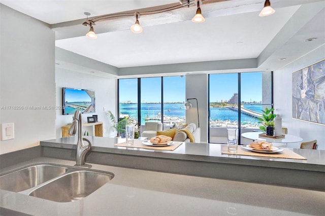 kitchen with sink, a wealth of natural light, and a water view