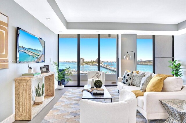 living room with a water view and floor to ceiling windows