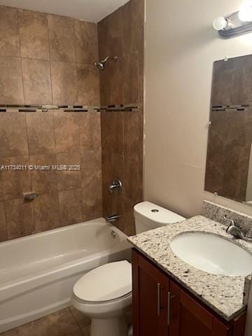 full bathroom featuring tiled shower / bath, toilet, tile patterned floors, and vanity