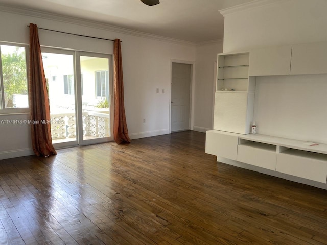 unfurnished living room with crown molding and dark hardwood / wood-style flooring