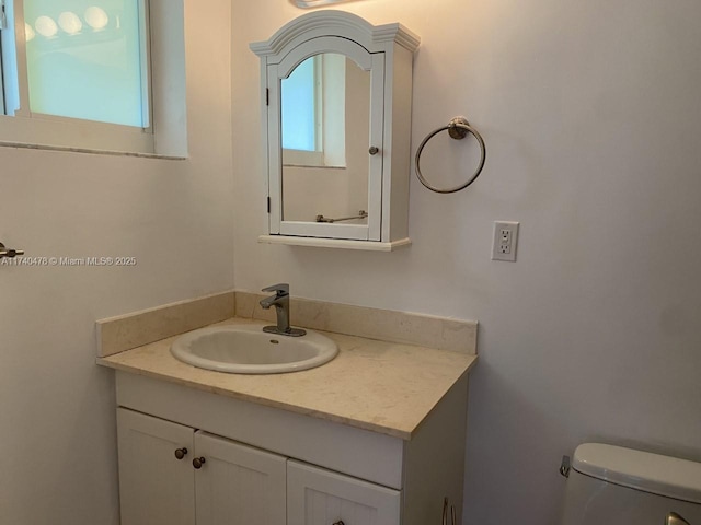 bathroom featuring vanity and toilet