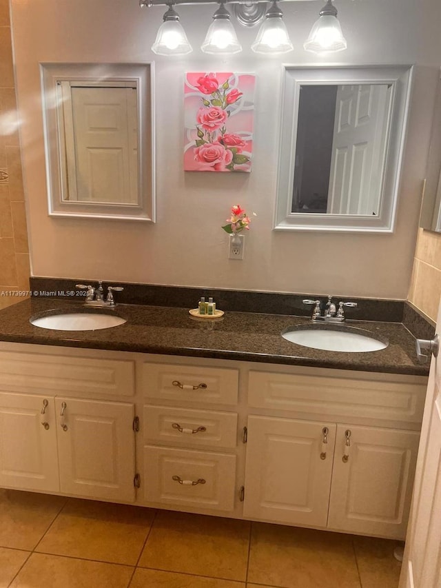 full bath with a sink and tile patterned floors