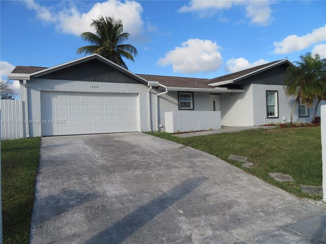 ranch-style home with a garage and a front lawn