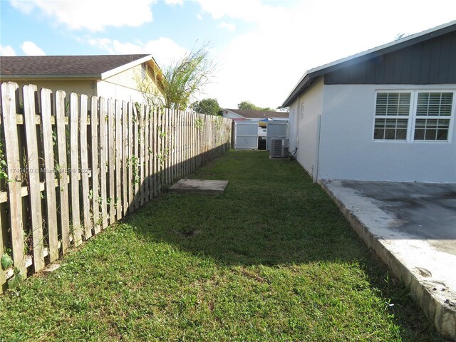 view of yard featuring central air condition unit