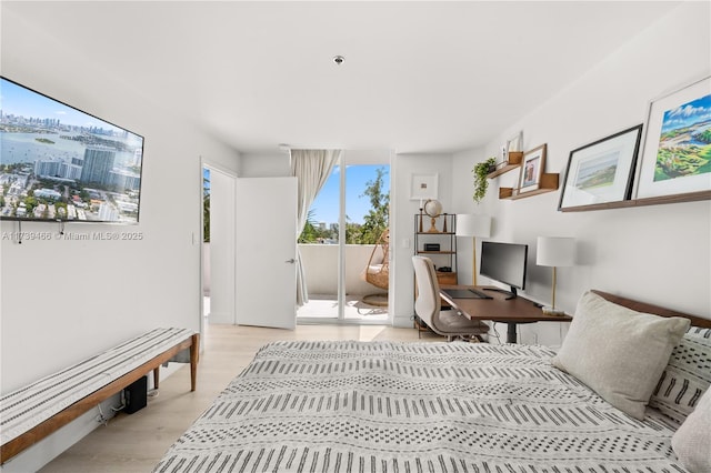 bedroom with light wood-type flooring and access to outside