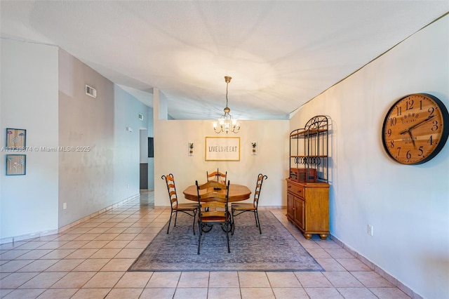 tiled dining space with a notable chandelier