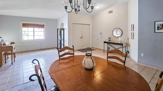 tiled dining room with lofted ceiling and a notable chandelier