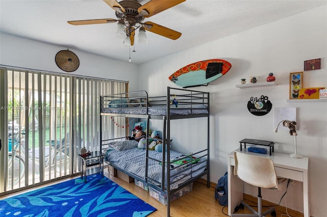 bedroom featuring ceiling fan, a textured ceiling, and hardwood / wood-style floors