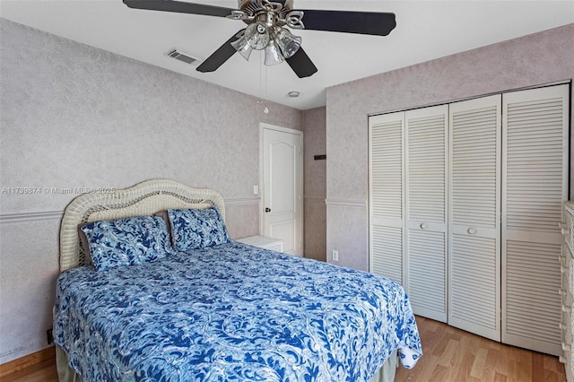 bedroom with light wood-type flooring, a closet, and ceiling fan