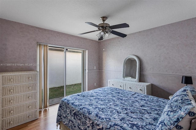 bedroom with ceiling fan, light hardwood / wood-style floors, and access to outside