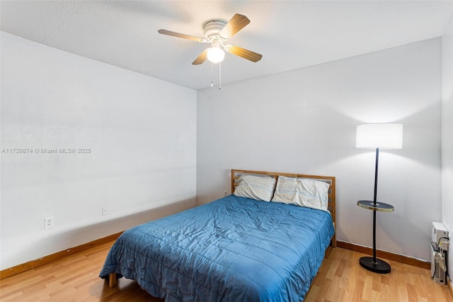 bedroom with ceiling fan and hardwood / wood-style floors