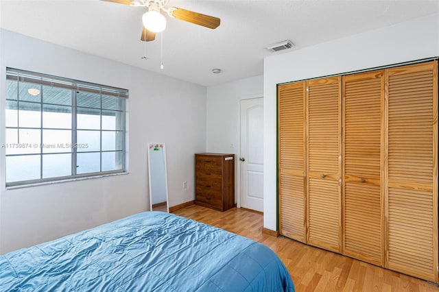 bedroom with ceiling fan, light hardwood / wood-style flooring, and a closet