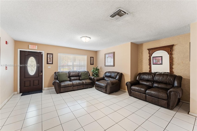 tiled living room featuring a textured ceiling