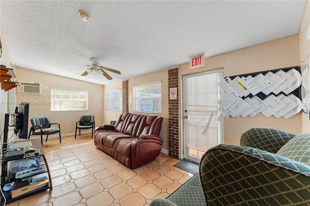 living room with ceiling fan, a textured ceiling, and an AC wall unit