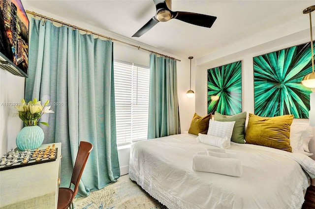 bedroom featuring ceiling fan and multiple windows