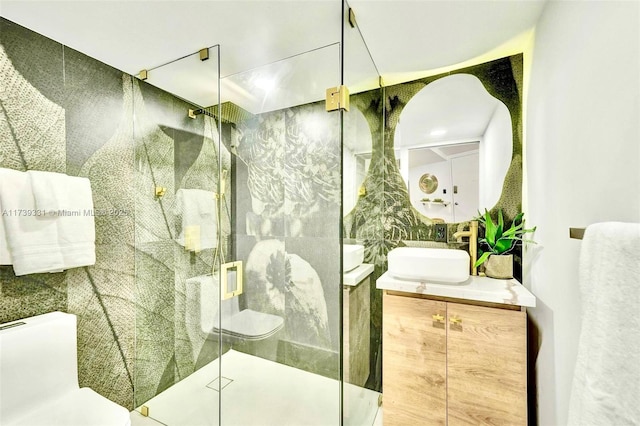 bathroom with vanity, a shower with shower door, and toilet