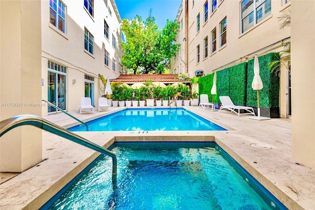 view of swimming pool featuring a patio and a pergola