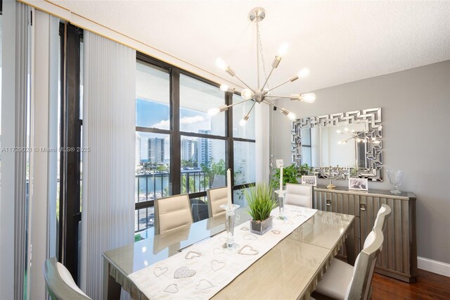 dining space with a water view, dark hardwood / wood-style floors, and an inviting chandelier