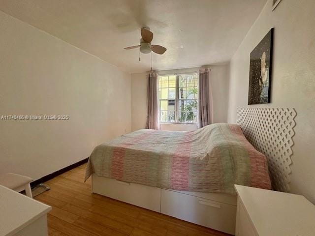 bedroom with ceiling fan and light wood-type flooring