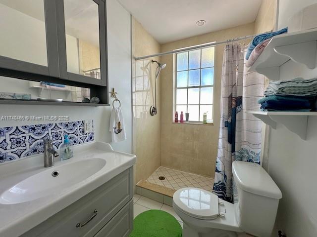 bathroom featuring vanity, toilet, and a shower with shower curtain