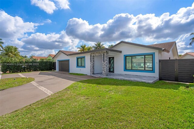 view of front facade with a garage and a front lawn