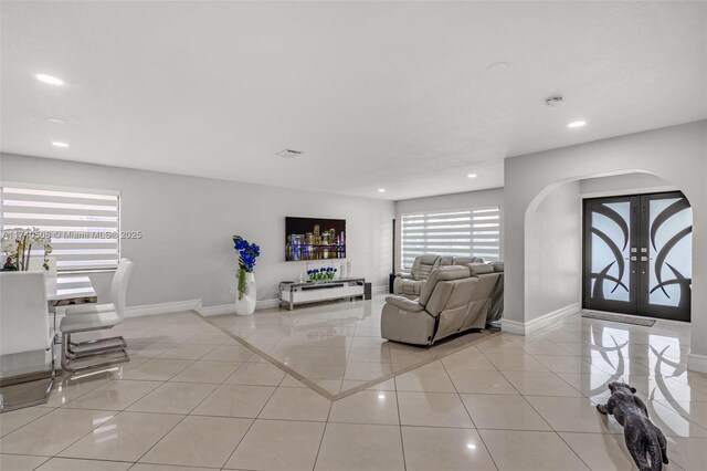 tiled living room featuring french doors