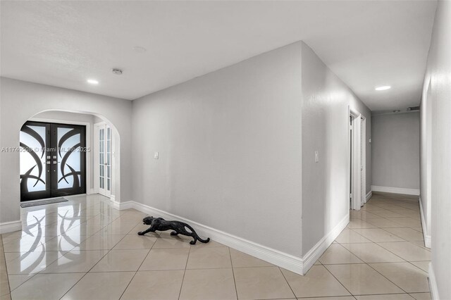 tiled foyer featuring french doors