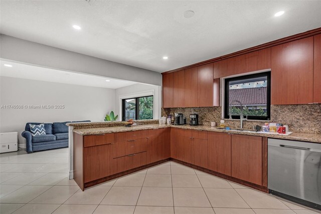 kitchen featuring sink, light tile patterned floors, dishwasher, and backsplash