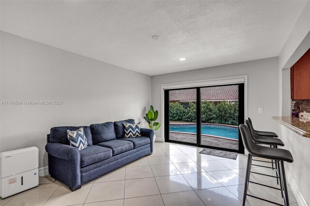 tiled living room with a textured ceiling