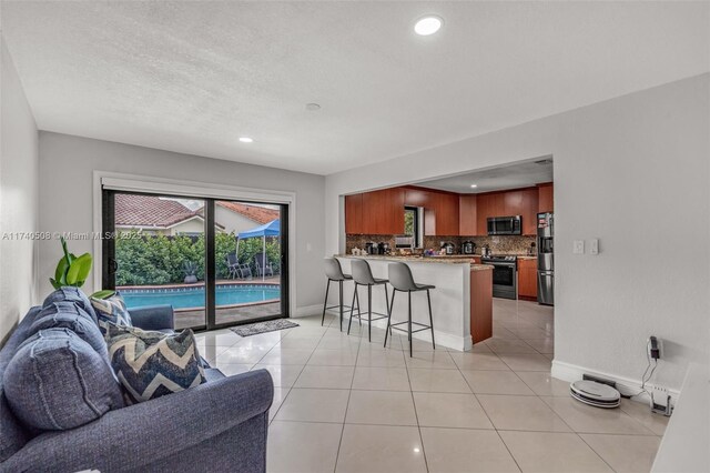 living room featuring light tile patterned flooring and a textured ceiling