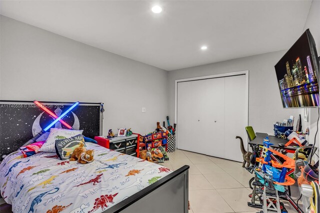 tiled bedroom featuring a closet