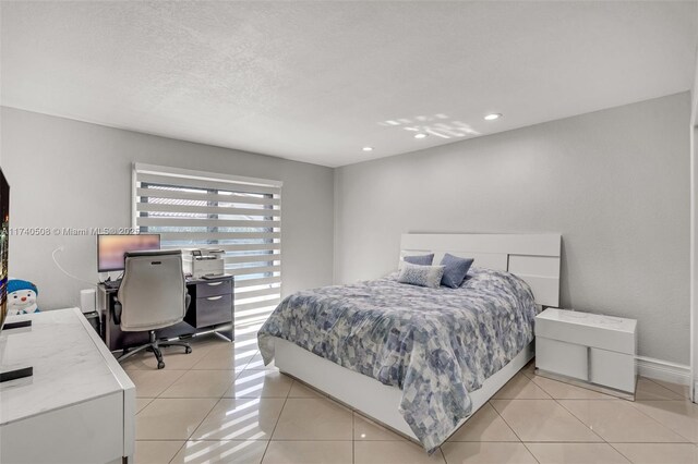 tiled bedroom with a textured ceiling