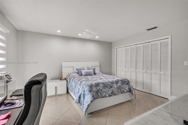 bedroom featuring light tile patterned floors and a closet