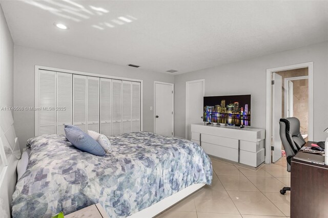 tiled bedroom featuring a closet