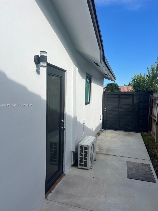 view of side of property featuring ac unit and a patio area