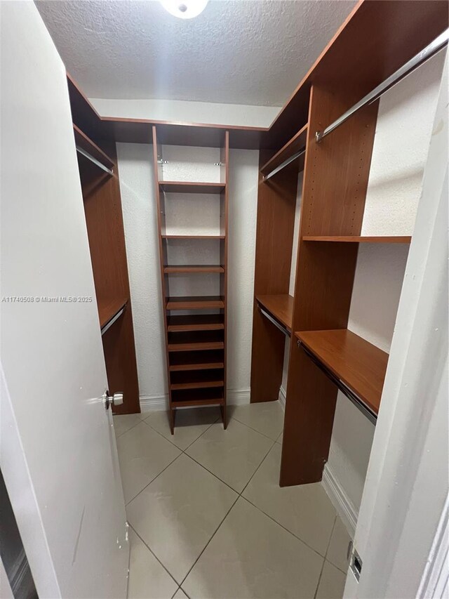 spacious closet featuring light tile patterned floors