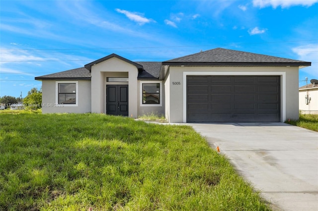 ranch-style house featuring a garage and a front yard