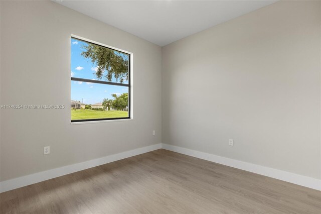 unfurnished room with light wood-type flooring